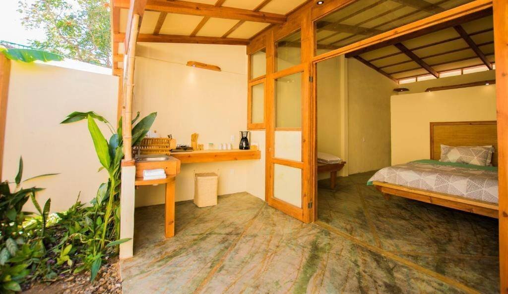 Galería Suites San Pancho: view into a suite through its wood-framed glass door